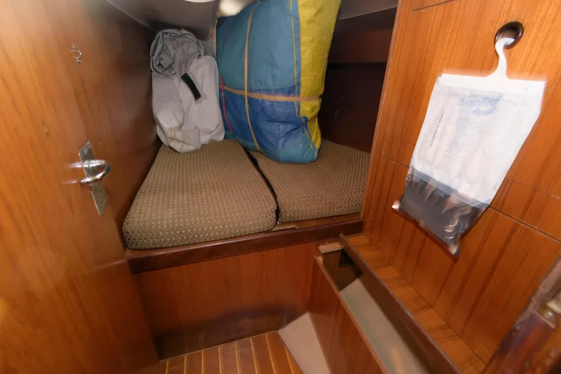 Slide: The Image of Small cabin interior of 1985 Beneteau 42 First sailboat with bedding and storage. - 9