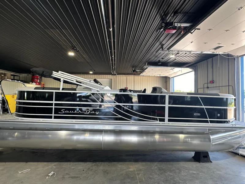 The Image of 2024 South Bay 224RSLE pontoon boat in a storage facility. - 0