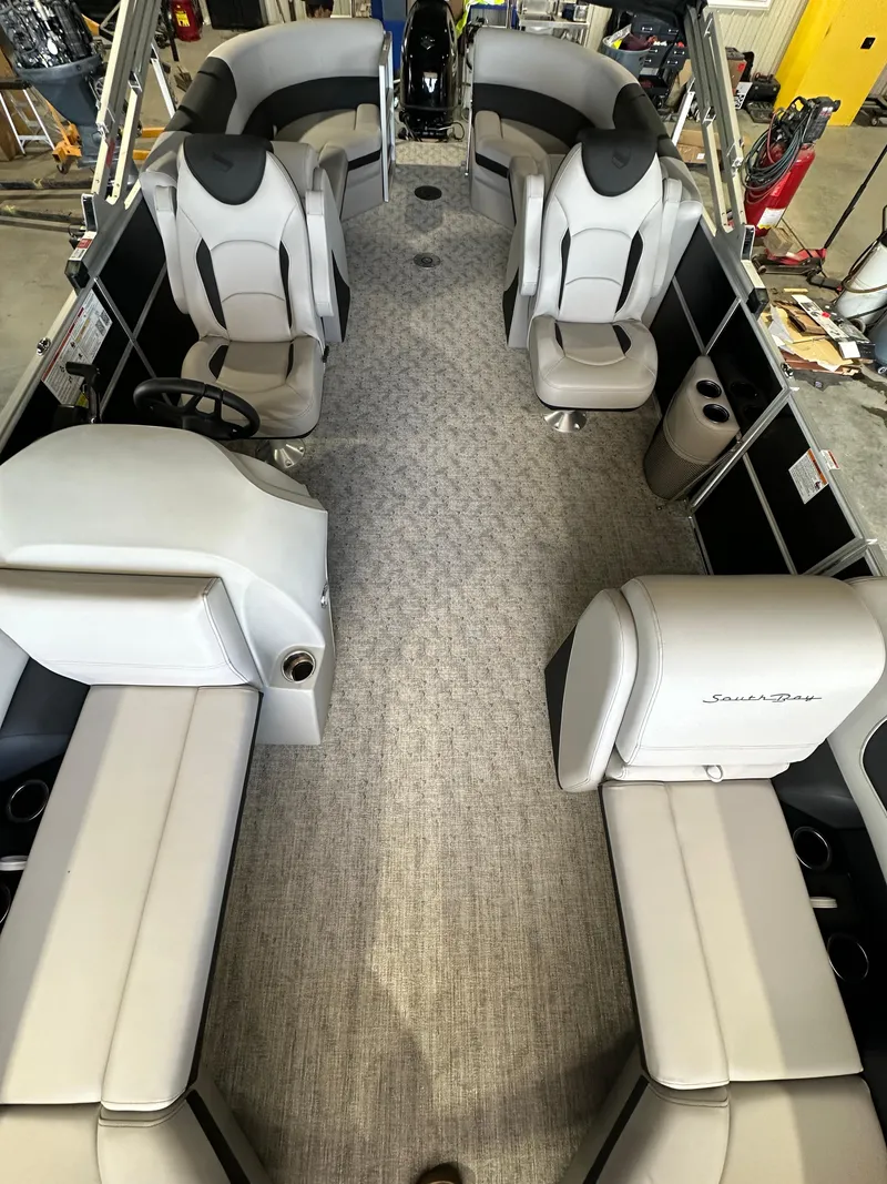 Slide: The Image of 2024 South Bay 224RSLE pontoon boat interior with gray seating and carpet. - 3