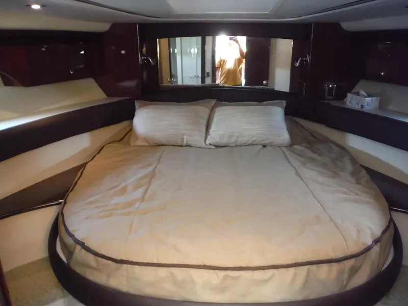 Slide: The Image of Luxurious bedroom in 2014 Meridian 441 Sedan yacht with a large bed and modern decor. - 11