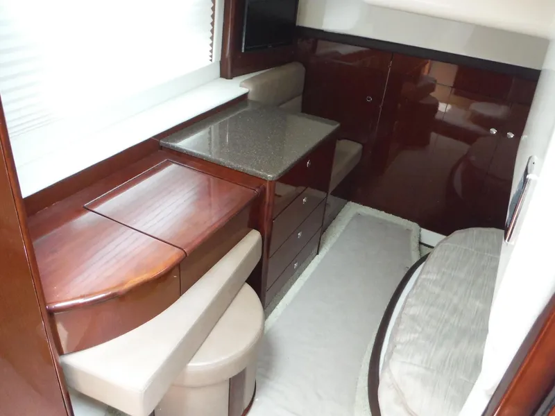 Slide: The Image of 2014 Meridian 441 Sedan interior with wooden cabinetry and seating area. - 14