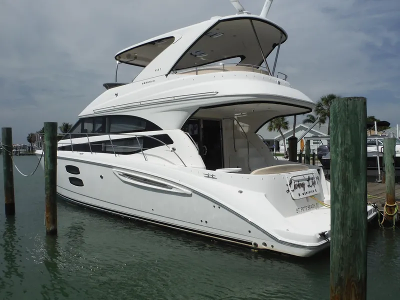 Slide: The Image of 2014 Meridian 441 Sedan yacht docked at marina. - 2