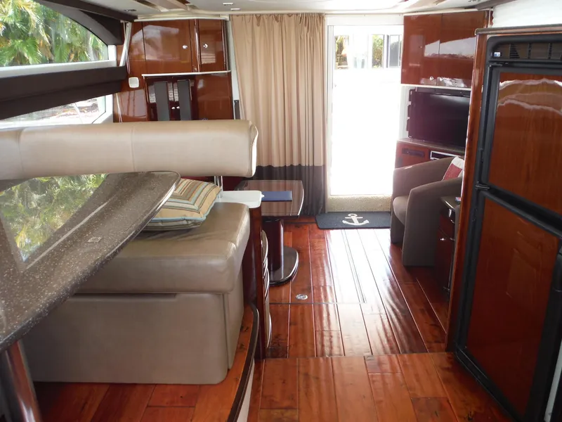 Slide: The Image of 2014 Meridian 441 Sedan yacht interior with polished wood floors and modern furnishings. - 21