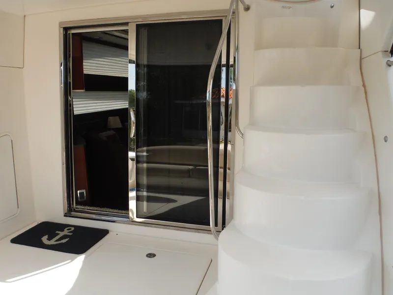 Slide: The Image of 2014 Meridian 441 Sedan yacht with white stairs and sliding glass door. - 28