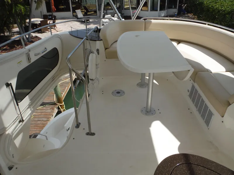 Slide: The Image of 2014 Meridian 441 Sedan yacht with spacious outdoor seating and dining area. - 31