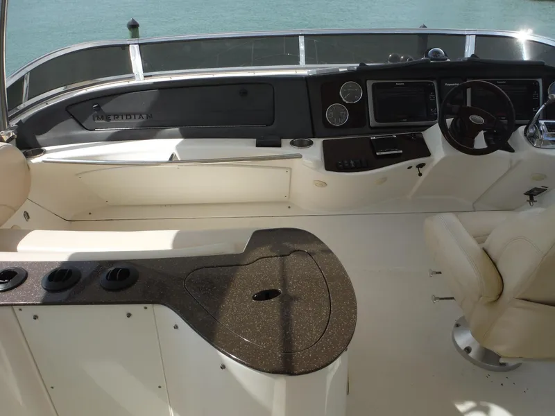 Slide: The Image of 2014 Meridian 441 Sedan boat helm with modern controls and seating. - 32