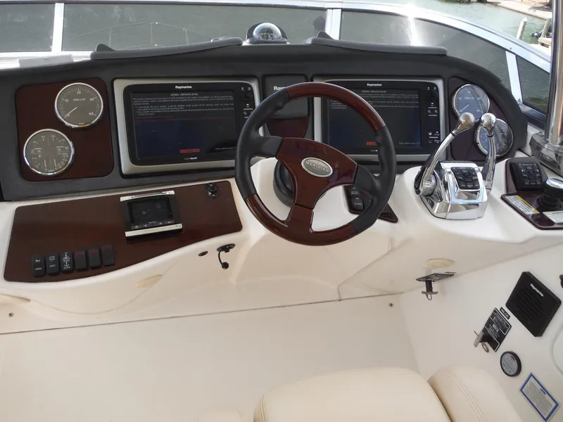 Slide: The Image of 2014 Meridian 441 Sedan helm with steering wheel, navigation screens, and control panels. - 33