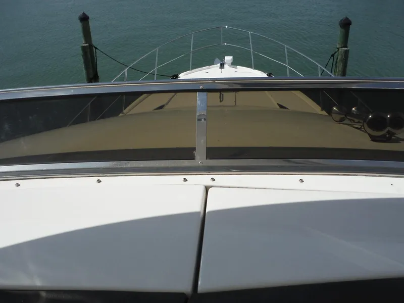 Slide: The Image of View from the bow of a 2014 Meridian 441 Sedan yacht docked at a marina. - 36