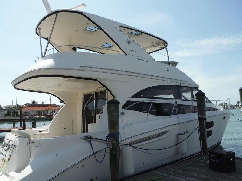 Slide: The Image of 2014 Meridian 441 Sedan yacht docked at a marina. - 49
