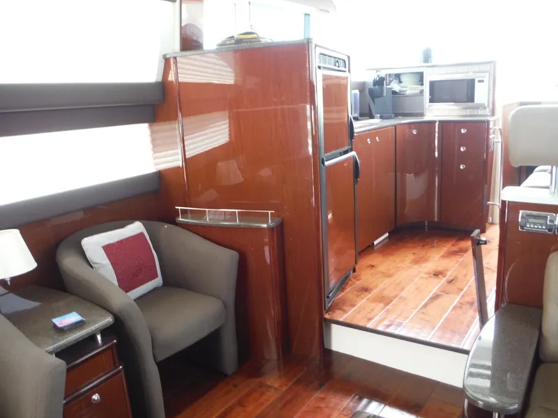 Slide: The Image of 2014 Meridian 441 Sedan yacht interior with modern kitchen and seating area. - 6
