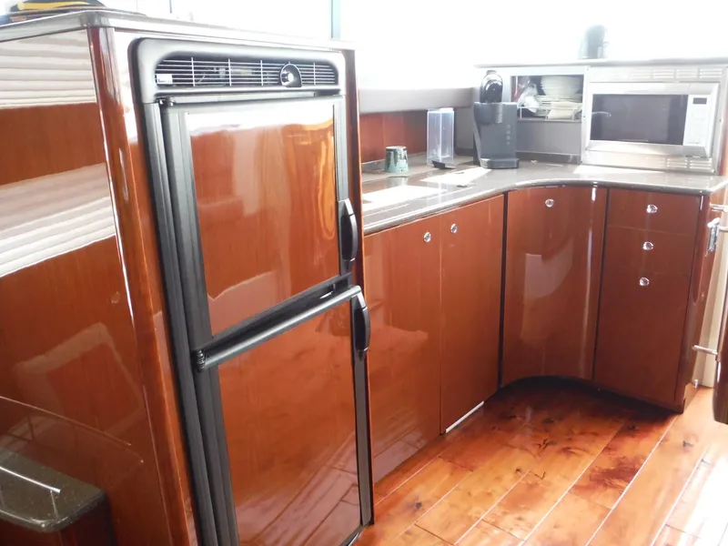 Slide: The Image of 2014 Meridian 441 Sedan kitchen with wood cabinets, refrigerator, and microwave. - 8