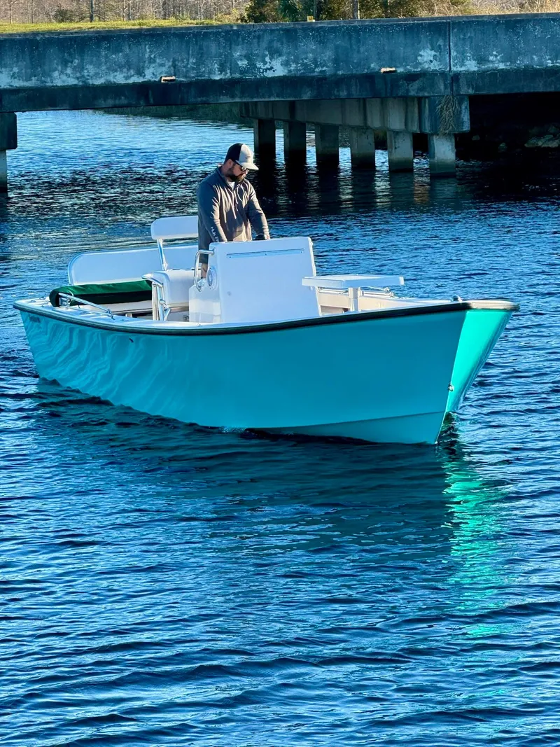 Slide: The Image of 2024 Rambo 22 Center Console boat on water with person at helm. - 10