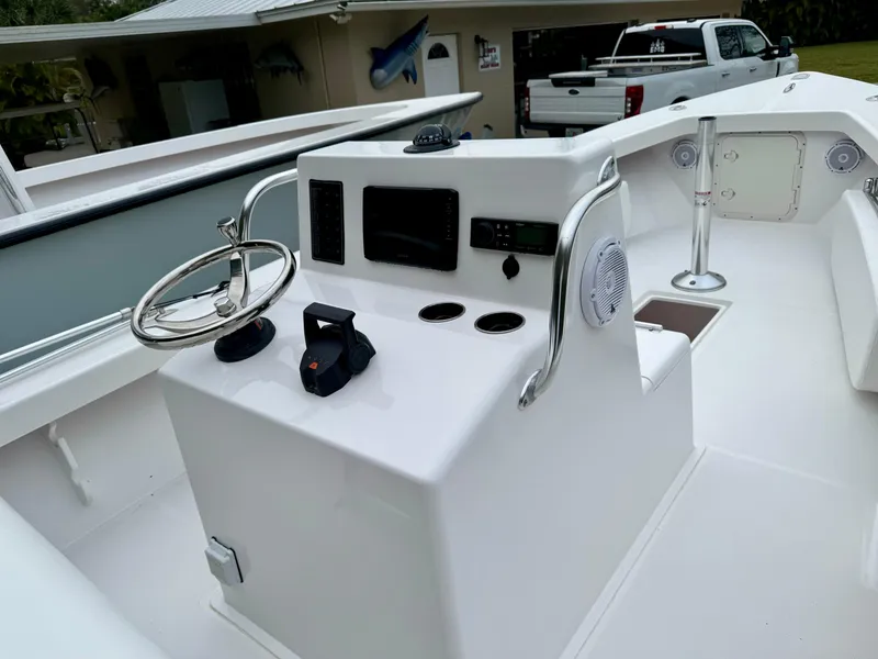 Slide: The Image of 2024 Rambo 22 Center Console boat dashboard with steering wheel and controls. - 12