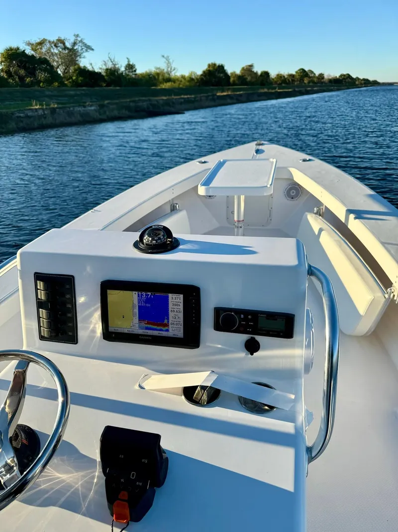 Slide: The Image of 2024 Rambo 22 Center Console boat on a calm river. - 13