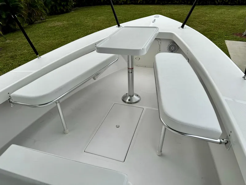 Slide: The Image of 2024 Rambo 22 Center Console boat with white seating and table. - 19