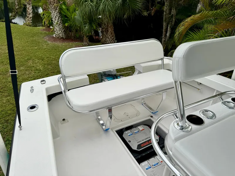 Slide: The Image of 2024 Rambo 22 Center Console boat with white seating and battery compartment. - 25