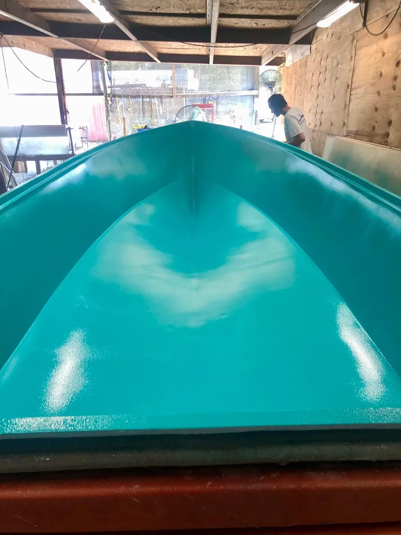 Slide: The Image of 2024 Rambo 22 Center Console boat under construction in a workshop. - 30