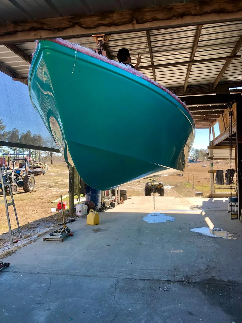 Slide: The Image of 2024 Rambo 22 Center Console boat in a workshop, hull view. - 31