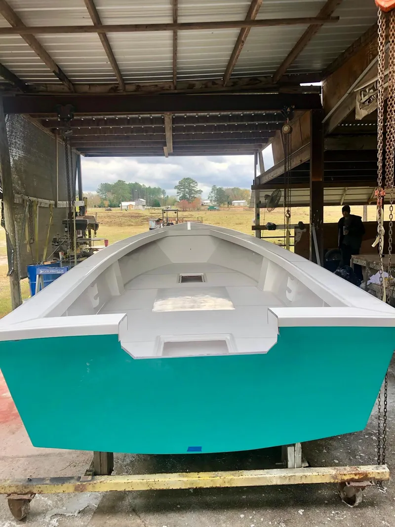 Slide: The Image of 2024 Rambo 22 Center Console boat in a workshop. - 34