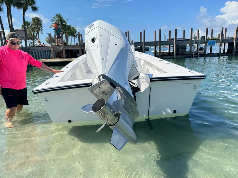 Slide: The Image of 2025 Rambo 22 Center Console boat in shallow water, with a person nearby. - 5