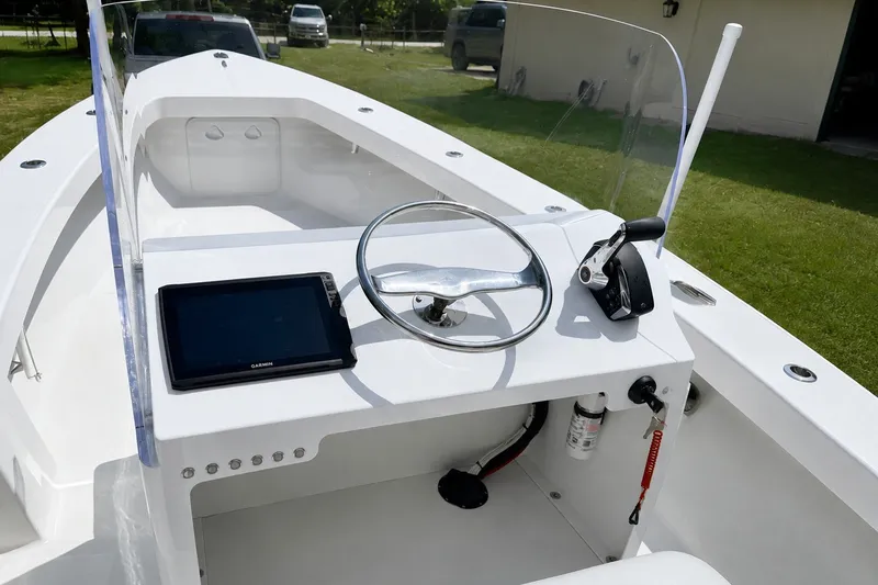 Slide: The Image of 2026 Rambo 22 Center Console boat interior with steering wheel and navigation system. - 13