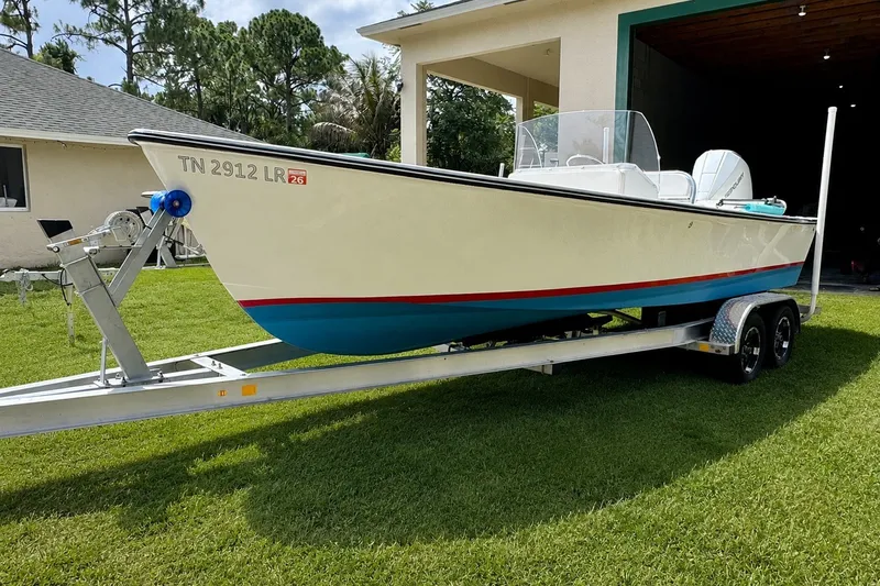 Slide: The Image of 2026 Rambo 22 Center Console boat on trailer, parked on grass. - 1
