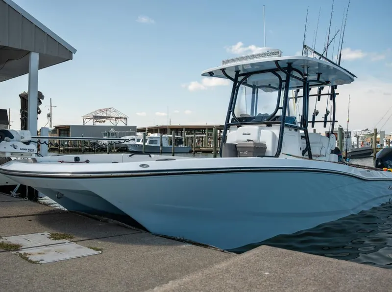 Slide: The Image of 2025 Sea Cat 26 Hybrid Catamaran docked at marina, side view. - 0