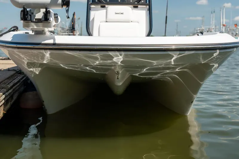 Slide: The Image of 2025 Sea Cat 26 Hybrid Catamaran docked, front view reflecting on water. - 1