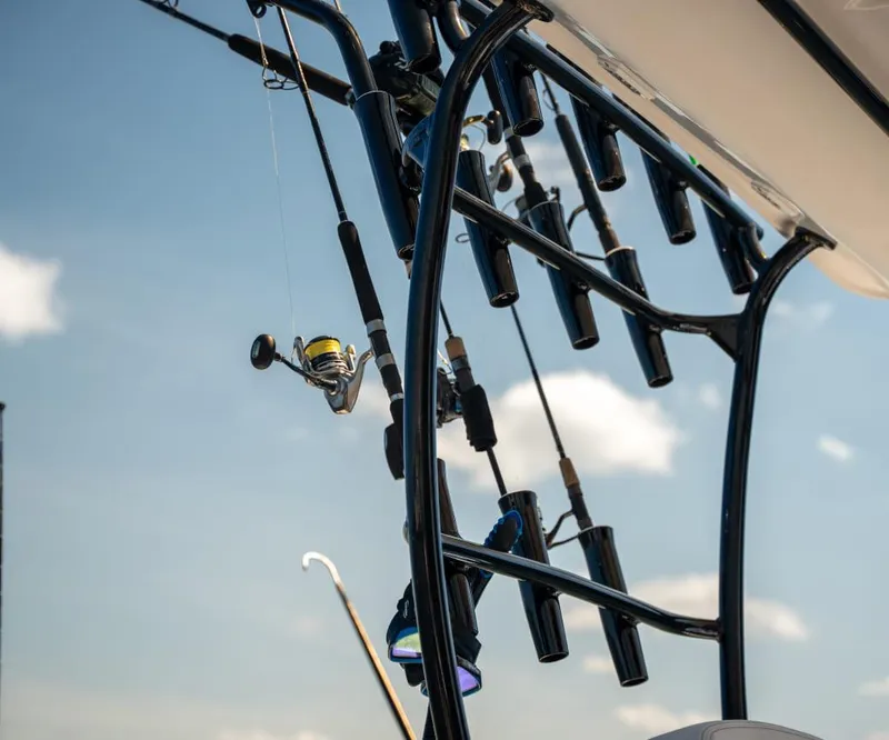 Slide: The Image of Fishing rods on a 2025 Sea Cat 26 Hybrid Catamaran against a clear sky. - 5