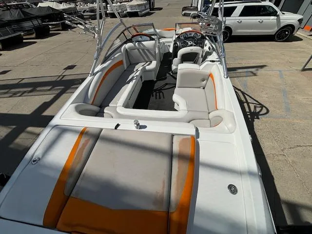 Slide: The Image of 2008 Tigé RZR 24 boat with white and orange interior, docked on a sunny day. - 10