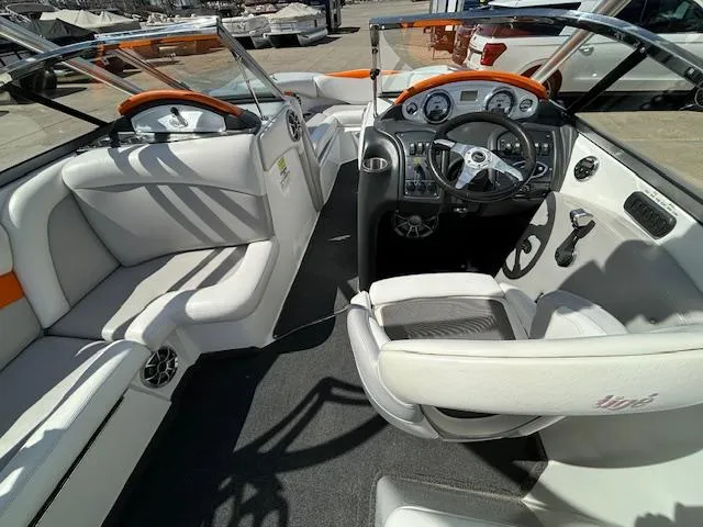 Slide: The Image of Interior of a 2008 Tigé RZR 24 boat with white and orange seating. - 13