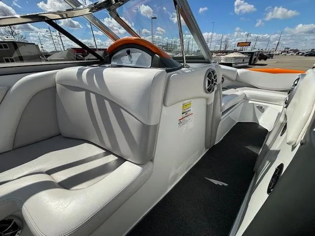 Slide: The Image of Interior of a 2008 Tigé RZR 24 boat with white and orange seating. - 21