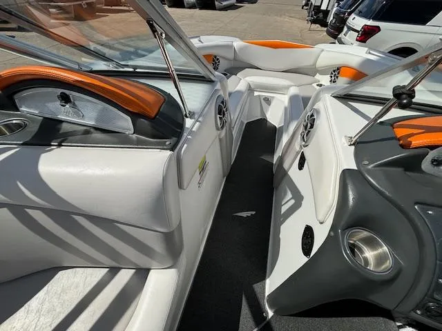Slide: The Image of 2008 Tigé RZR 24 boat interior with white and orange seating. - 22