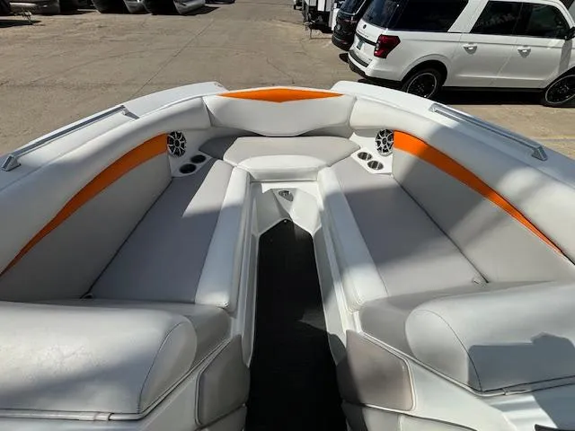 Slide: The Image of 2008 Tigé RZR 24 boat interior with white and orange seating. - 24