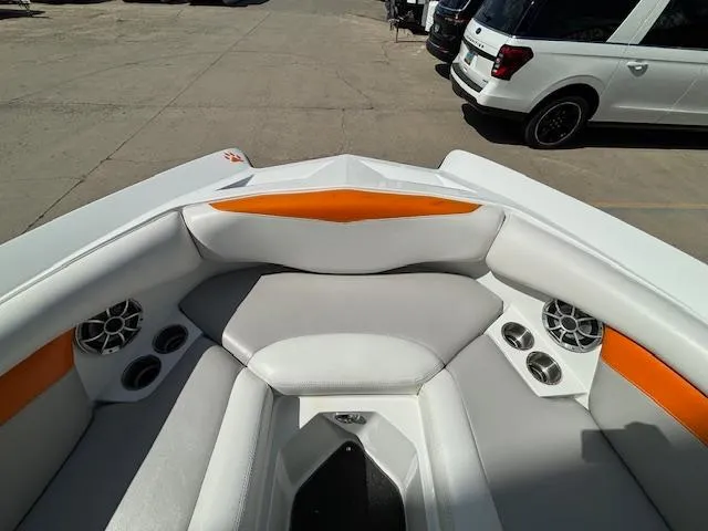 Slide: The Image of 2008 Tigé RZR 24 boat interior with white and orange seating and built-in speakers. - 25