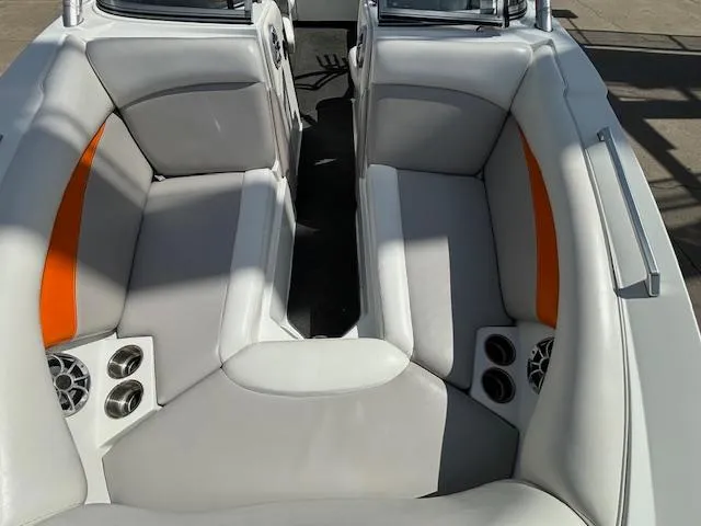 Slide: The Image of 2008 Tigé RZR 24 boat interior with gray and orange seating, cup holders, and speakers. - 26