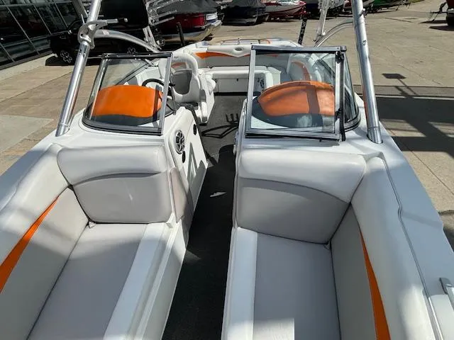 Slide: The Image of 2008 Tigé RZR 24 boat interior with white and orange seating. - 27
