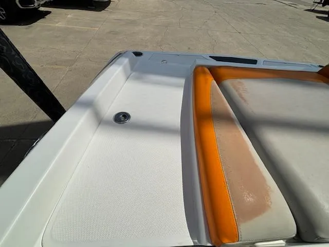Slide: The Image of 2008 Tigé RZR 24 boat with orange and white seating, rear deck view. - 35