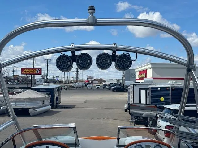 Slide: The Image of 2008 Tigé RZR 24 boat with tower speakers in a parking lot. - 38