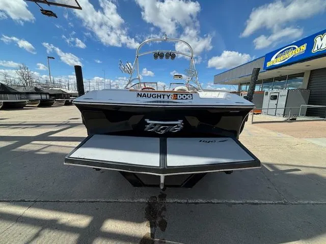 Slide: The Image of 2008 Tigé RZR 24 boat, rear view, docked at marina under blue sky. - 6