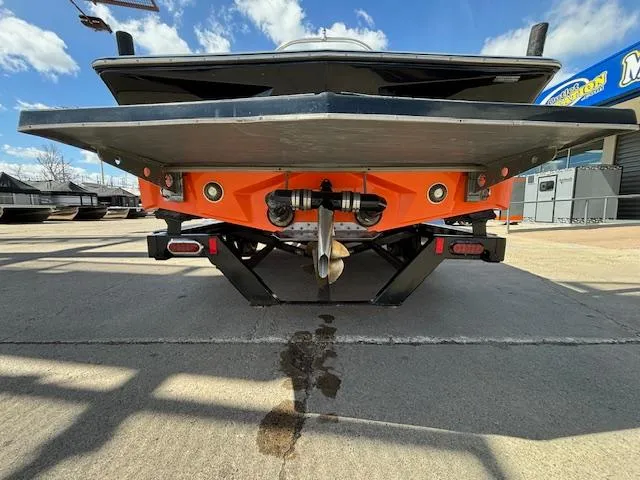 Slide: The Image of 2008 Tigé RZR 24 boat rear view with orange detailing and propeller. - 7