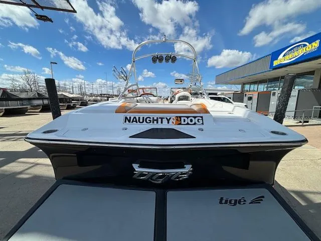 Slide: The Image of 2008 Tigé RZR 24 boat with Naughty Dog decal at a marina. - 8