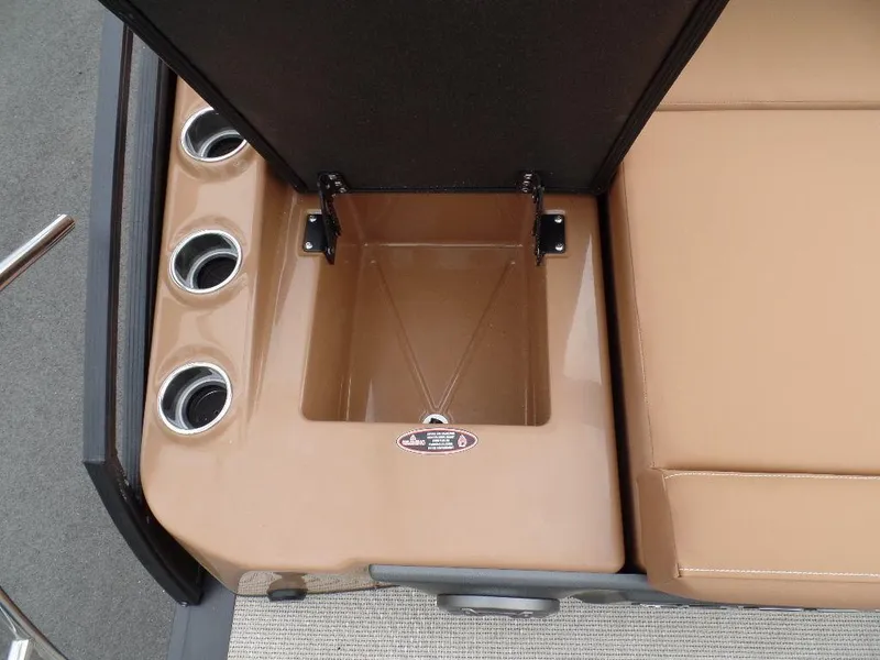 Slide: The Image of 2024 Harris Solstice 250 boat storage compartment with cup holders and tan seating. - 10