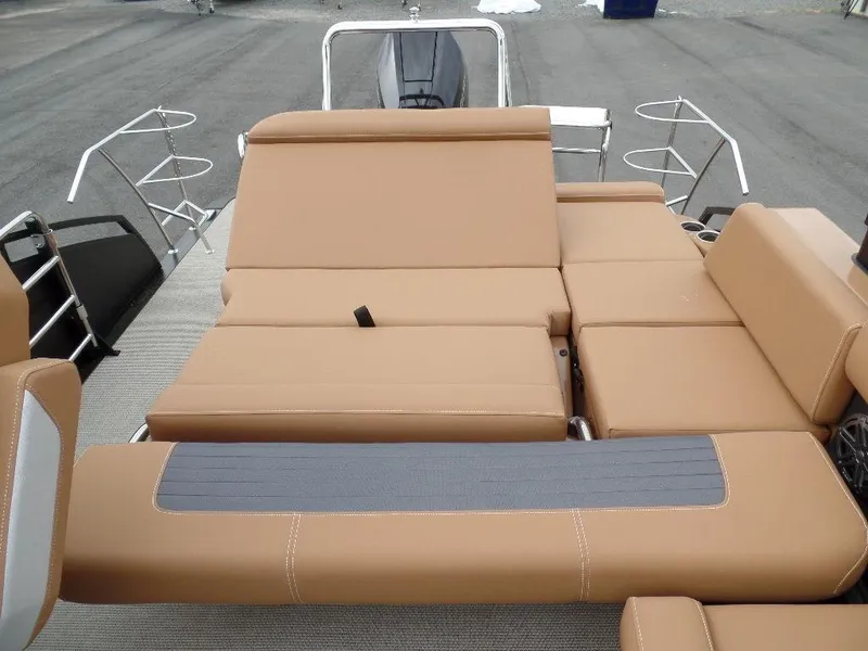 Slide: The Image of 2024 Harris Solstice 250 boat with tan seating and adjustable lounge area. - 12