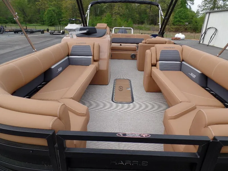Slide: The Image of 2024 Harris Solstice 250 pontoon boat with spacious tan seating and modern design. - 3