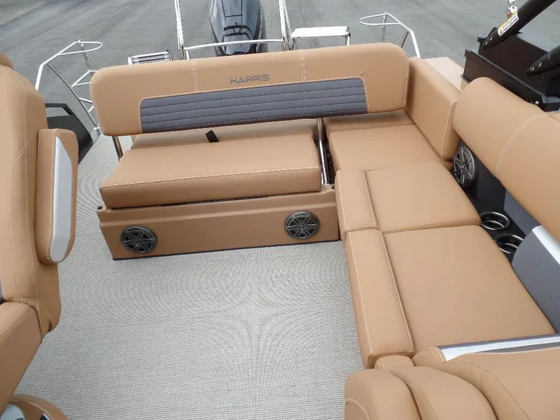 Slide: The Image of 2024 Harris Solstice 250 boat interior with tan seating and built-in speakers. - 7