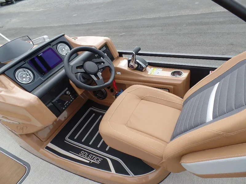 Slide: The Image of 2024 Harris Solstice 250 boat interior with tan seating and modern dashboard. - 8