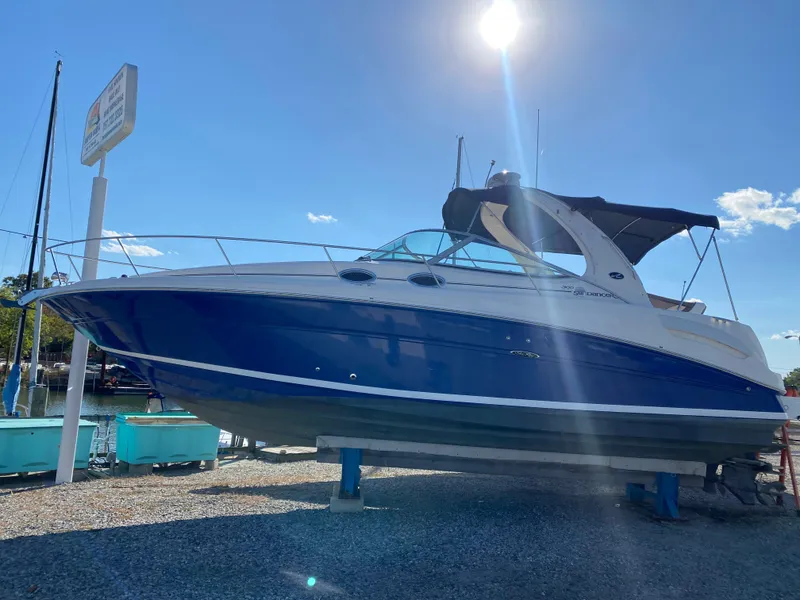 The Image of 2005 Sea Ray SUNDANCER 300 boat on display under a bright blue sky. - 0