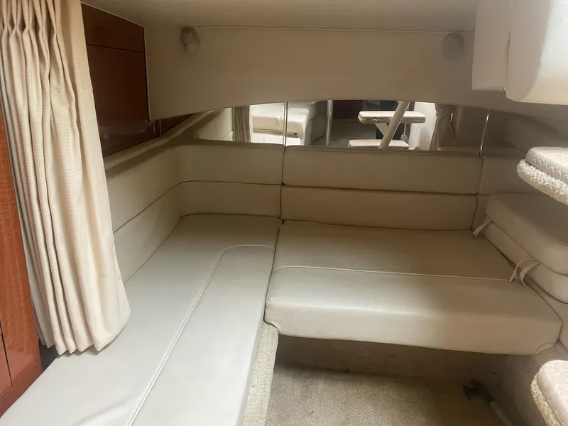 Slide: The Image of Interior cabin of a 2005 Sea Ray SUNDANCER 300 with beige seating and curtains. - 4