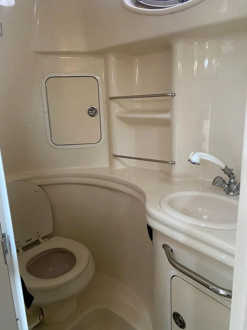 Slide: The Image of 2005 Sea Ray SUNDANCER 300 bathroom with toilet, sink, and storage shelves. - 5